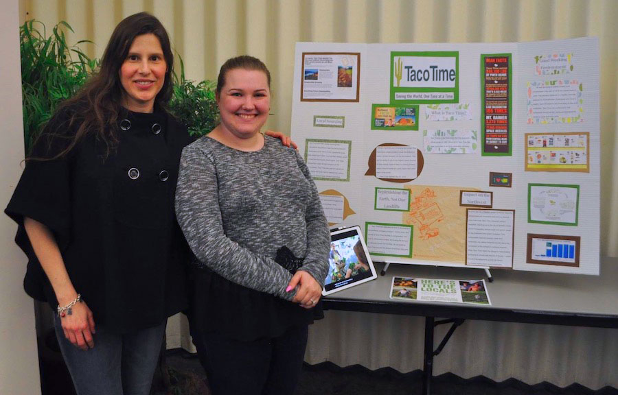 faculty mentor and student in front of research board presentation